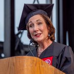 VIP in regalia speaking at lectern