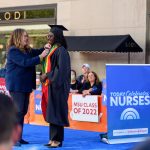 Student Aminata Coundoul receiving her pin