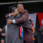 Joseph and Fevrius embracing on stage