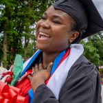 Fevrius walking on campus after convocation laughing
