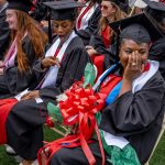 Fevrius at her seat after the proposal, laughing.