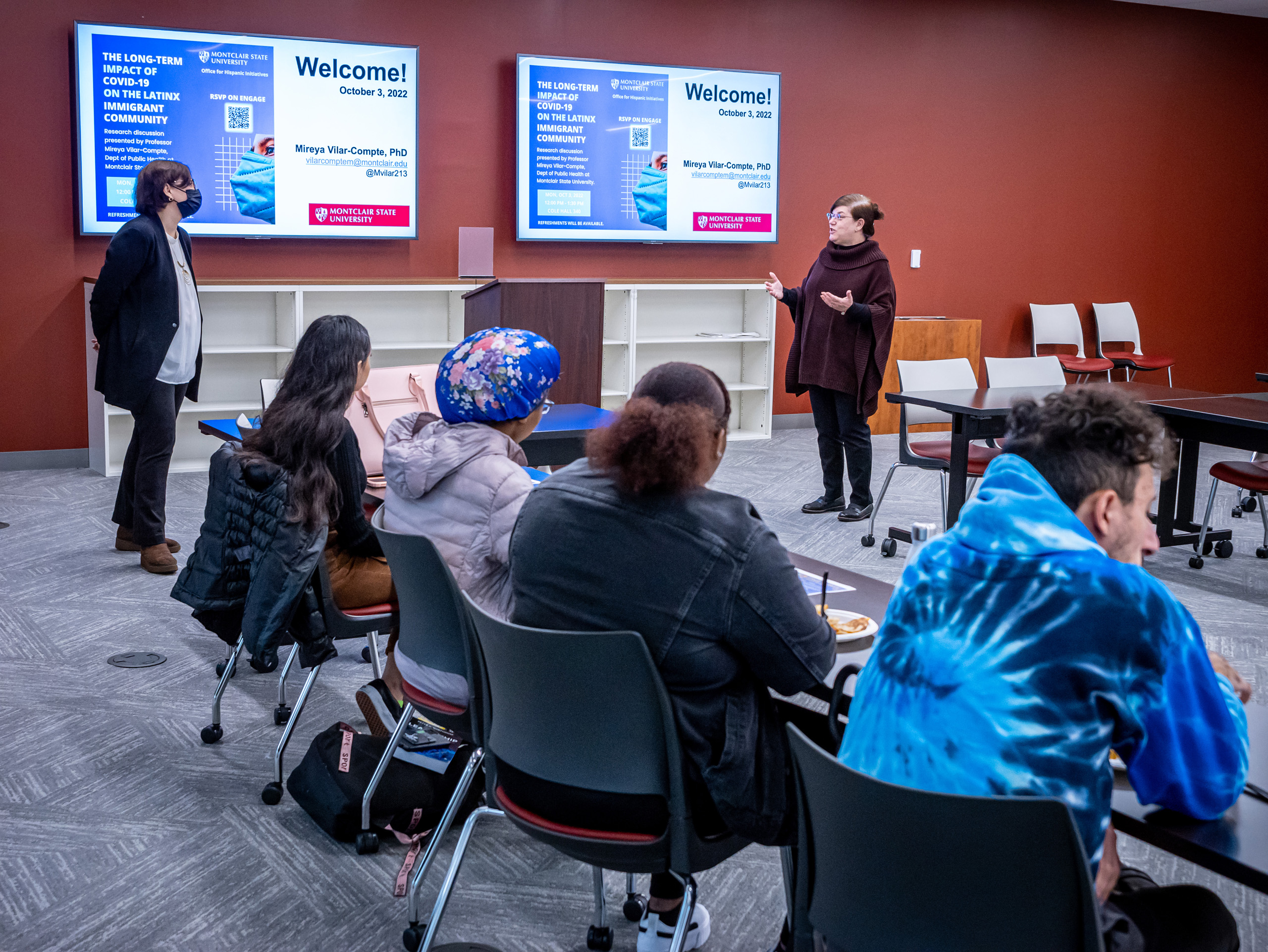 Mireya Vilar-Compte and Katia Paz Goldfarb talking at front of room