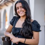 Student in front of arches