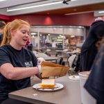 A student makes a sandwich.