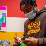 A man puts toothpaste into a bag.