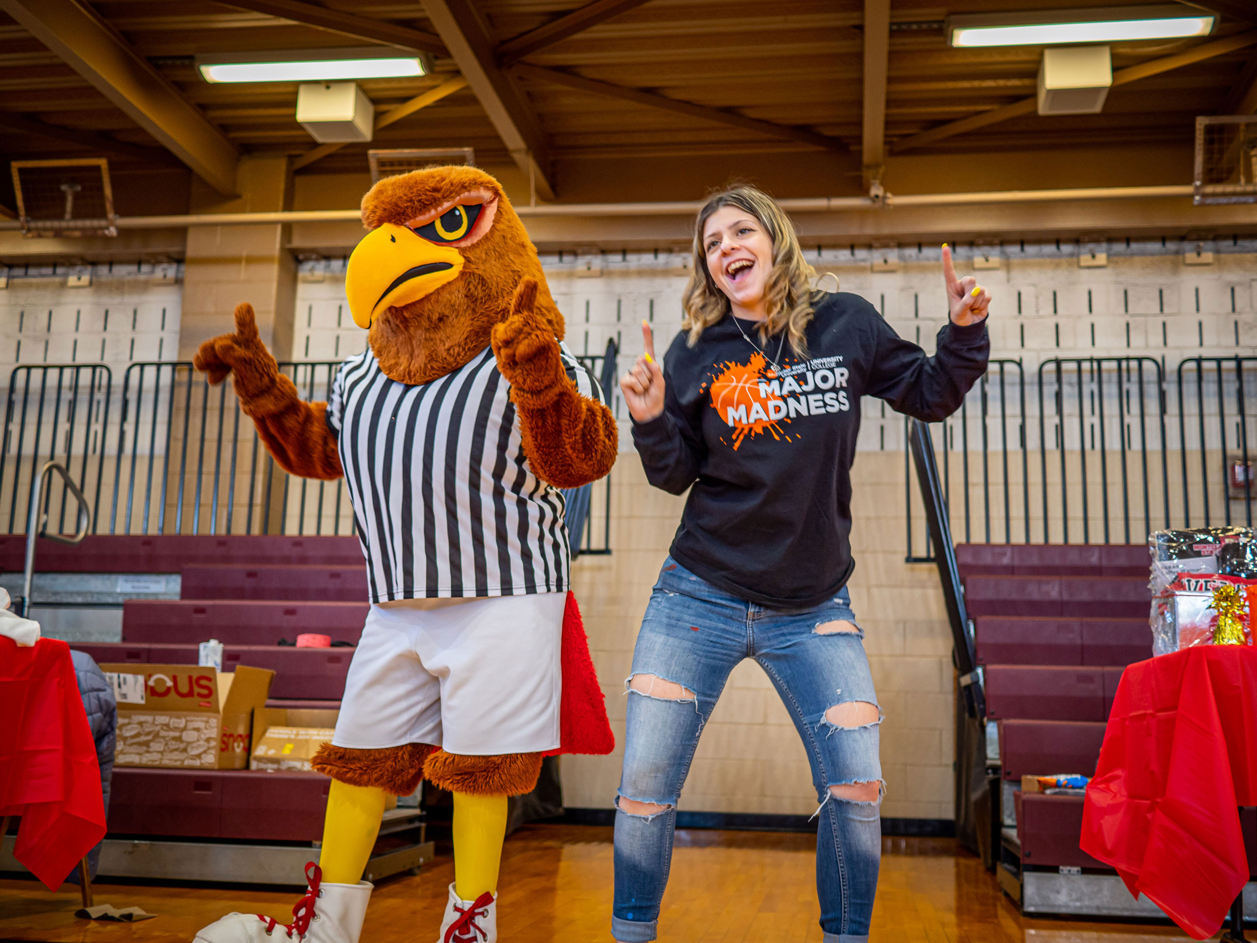 College mascot dances with a student.