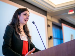 A student speaks from a lectern.