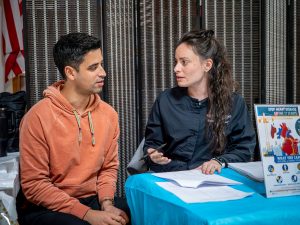 A nursing graduate speaks with a man.