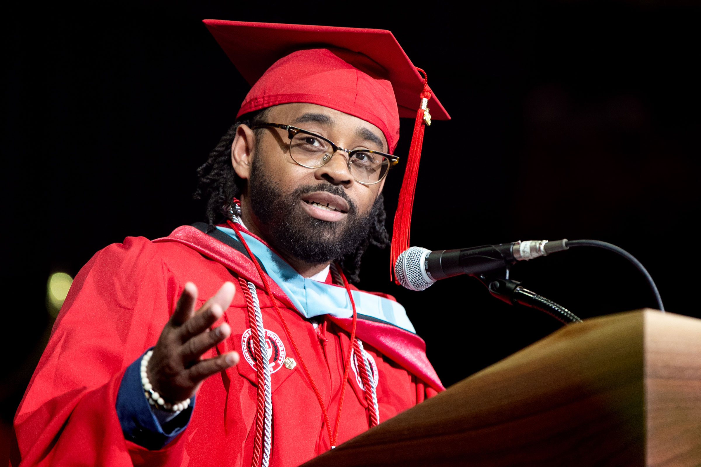 Master's degree recipient gives moving speech from podium at Commencement.