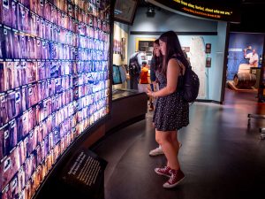 Two students look at a lighted museum exhibit.