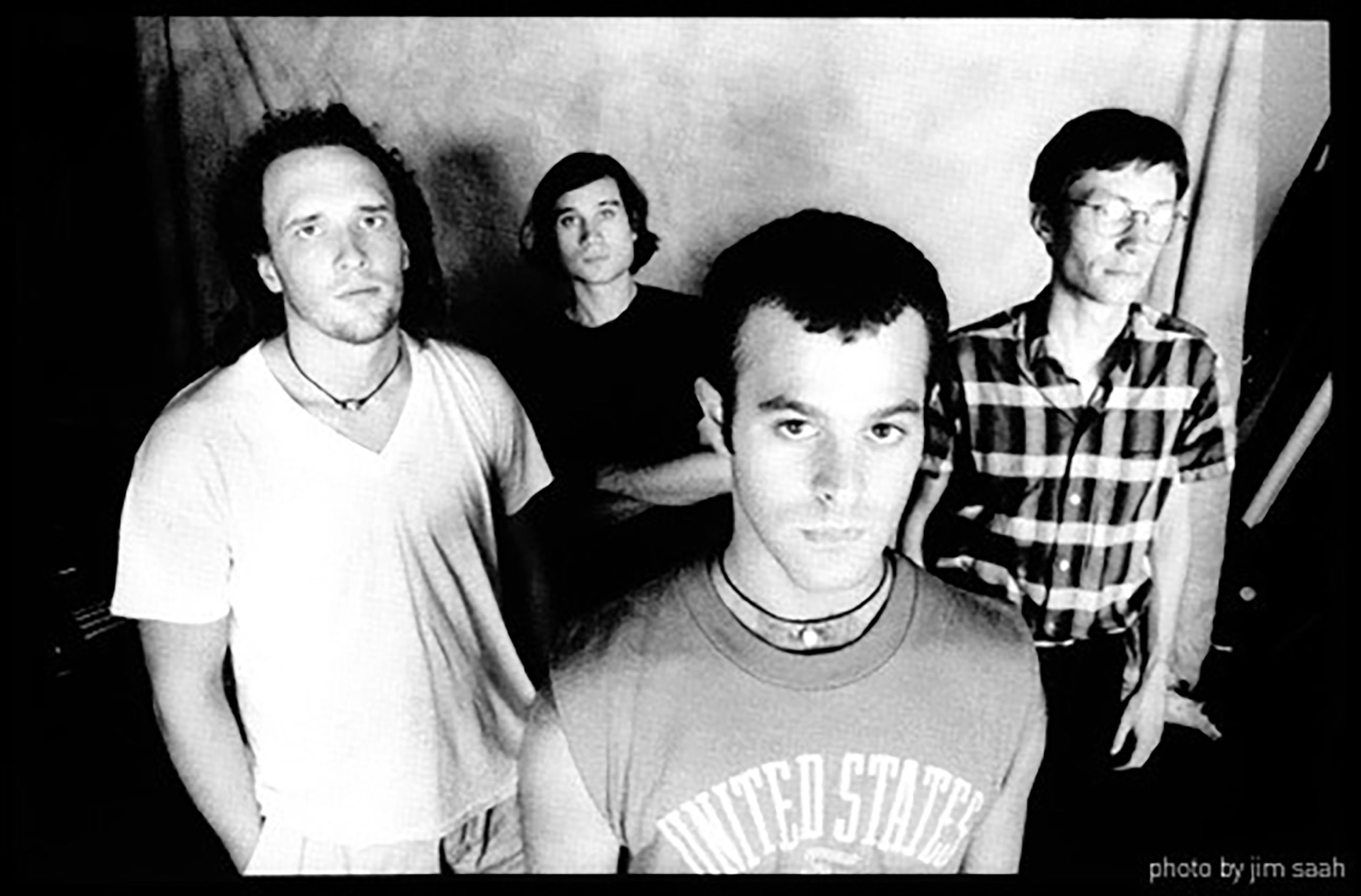 A black-and-white photo of four young men in the band Shudder to Think in the 1980s.