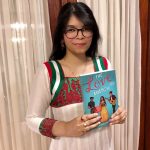 Priyanka Taslim holding her book Love Match.