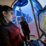 A student conducts testing on another student using the Bertec balance system.