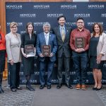 People who won awards pose for a photo with leaders on human trafficking.