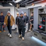 Players tour a locker room.