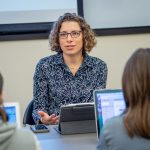  A professor gestures as she addresses her class. 