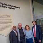 Baye Adofo Wilson, Charles J. Muth, Laura Muth and Jonathan Koppell stand in front of the information for The Charles J. Muth Museum of Hinchliffe Stadium.