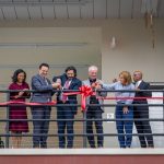 Six people cut the ribbon for The charles J. Muth Museum of Hinchliffe Stadium