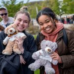 Two students with teddy bears.