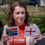 Student holds two world flags.