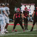 Red Hawks offensive lineman Cameron Siebert stands midfield.