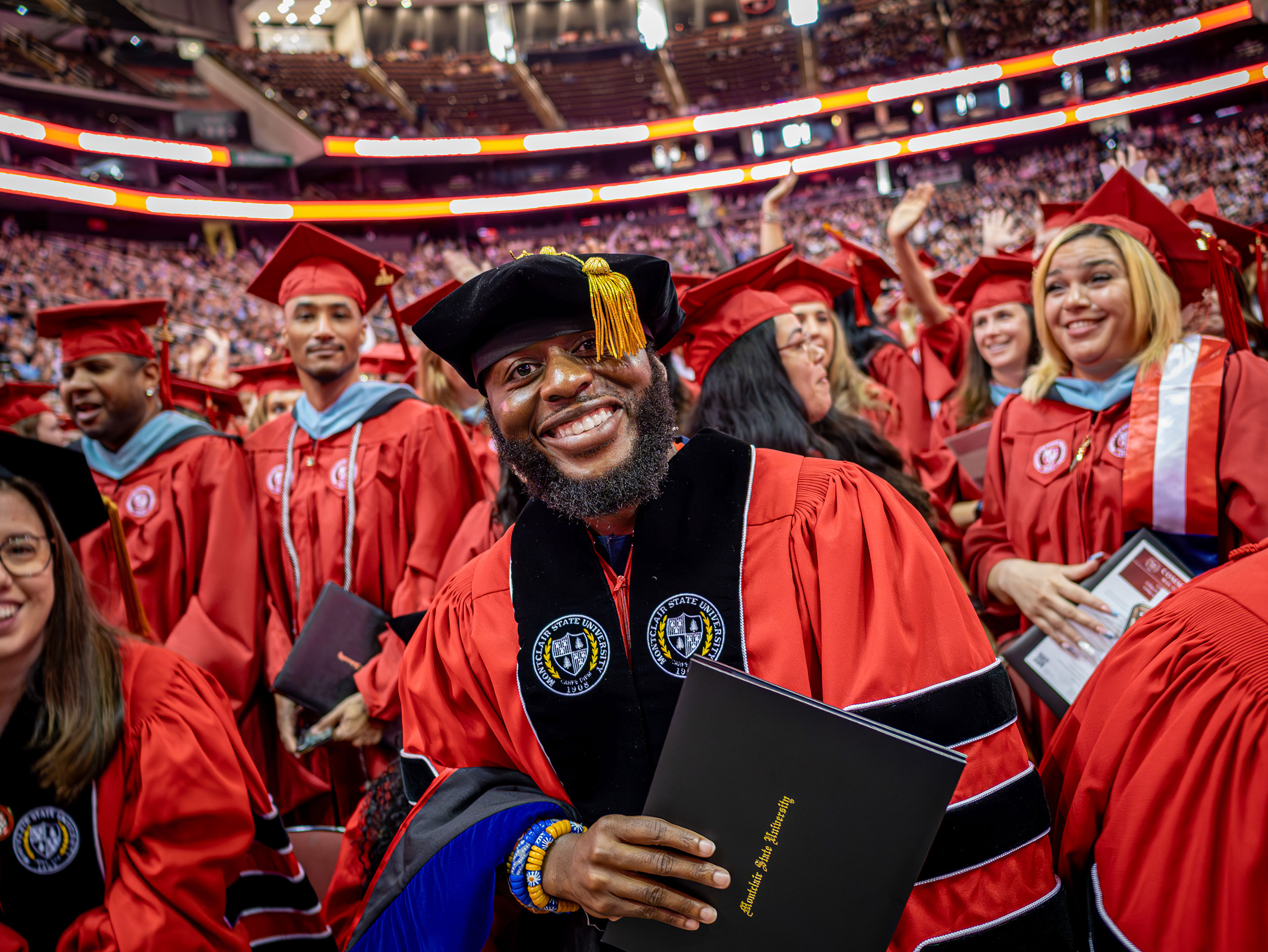 doctoral degree recipient smiles for the camera