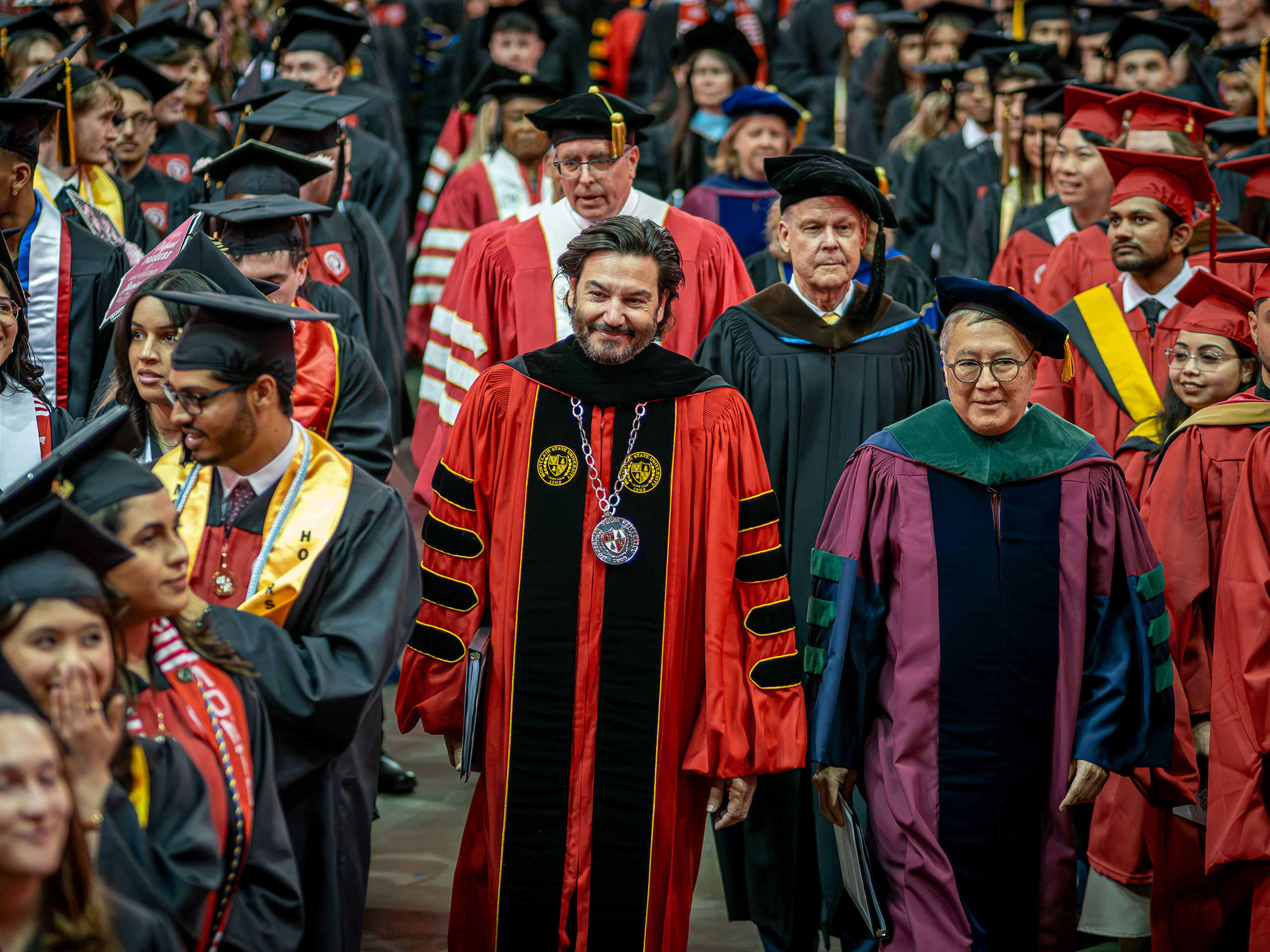 President Koppell and Provost Junius Gonzales walking toward the stage