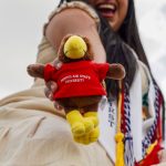 Aylin Alvarez-Santiago holds a mini stuffed bird mascot.