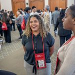 A recent graduate is seen speaking with other students