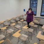 Stephanie Spitz gestures to chairs that are too small for larger students.
