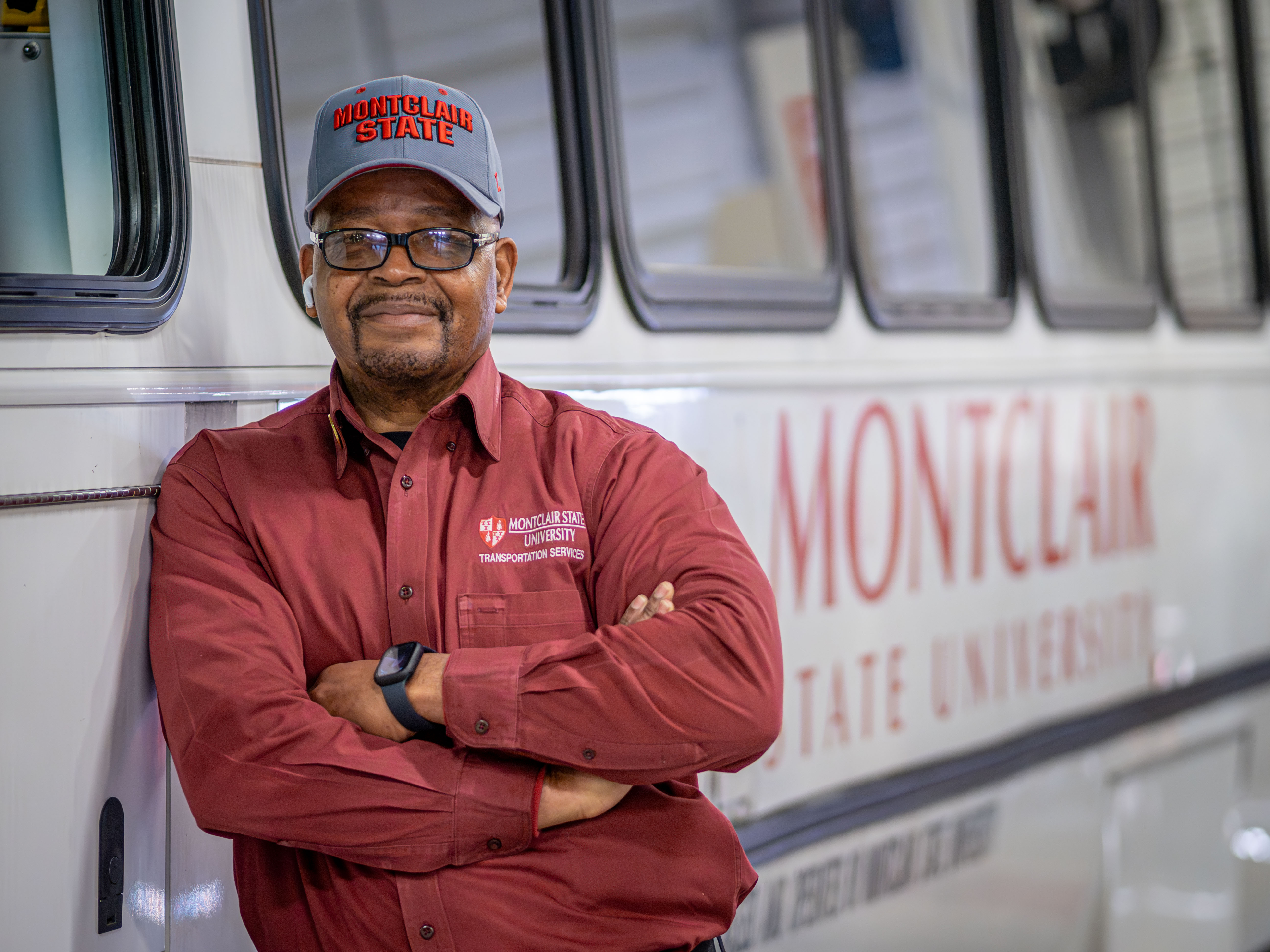 Frank Rivers leans against shuttle, arms crossed
