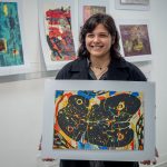 Grace Whitaker holds one of her art prints.