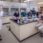 Students listen to Chemistry and Biochemistry Associate Professor David Talaga in the lab.