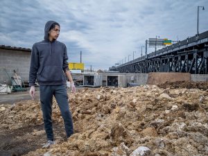 Godek looks out at the rooftop compost pile, where spent mushroom blocks break down into compost available to the community.