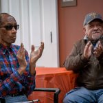 Veterans applaud after a song performance.