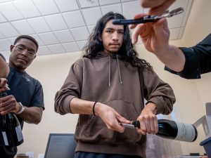 Godek uncorks a bottle of wine. (Photo by University Photographer Mike Peters)
