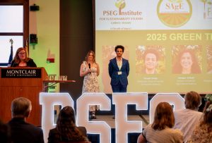 Amy Tuininga, director of the PSEG Institute for Sustainability Studies, stands at a podium speaking at the 10th Anniversary Gala and Launch Event. Two Green Team interns stand nearby as she introduces the 2025 cohort.