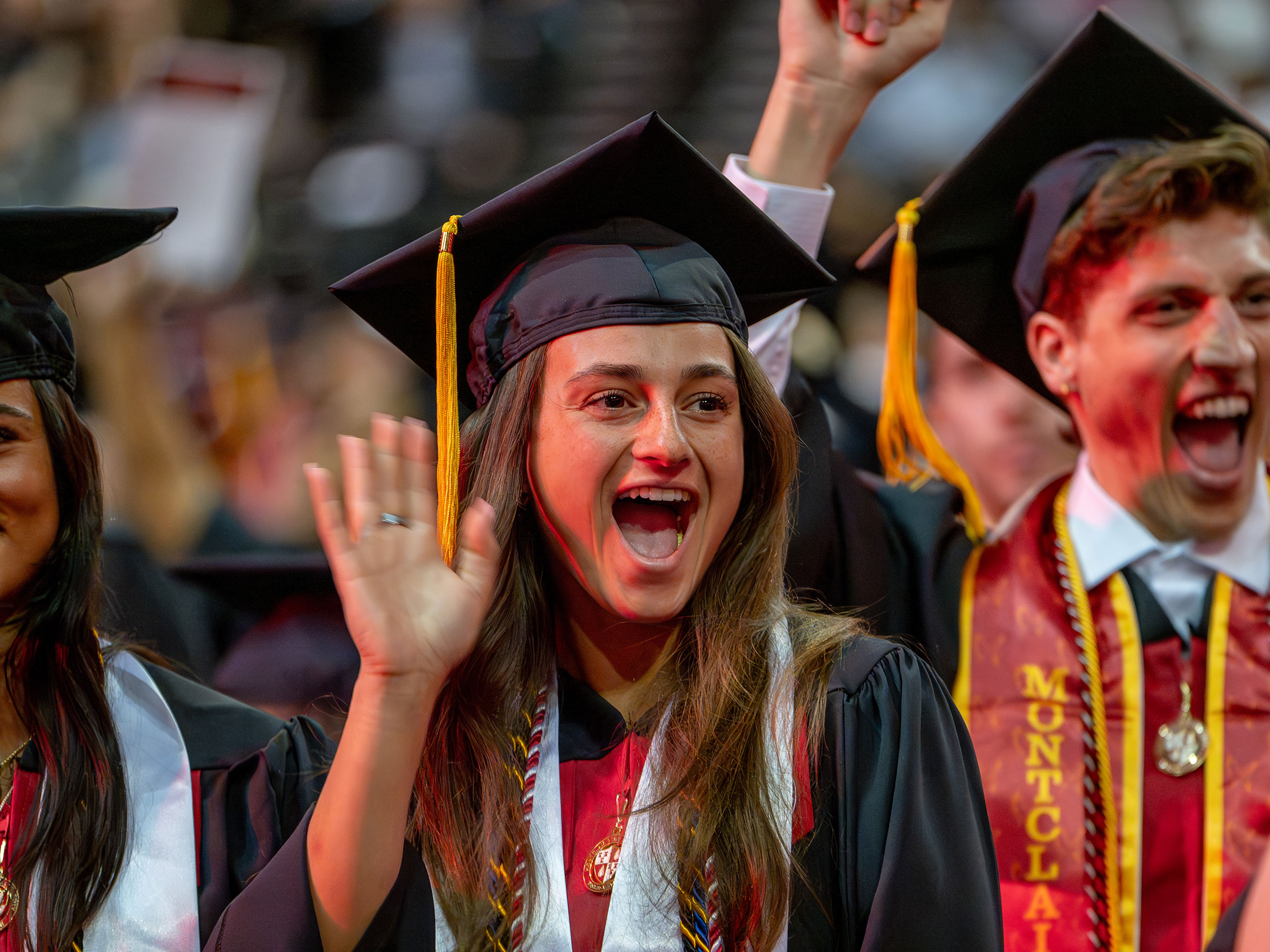 Graduates smiling and waving