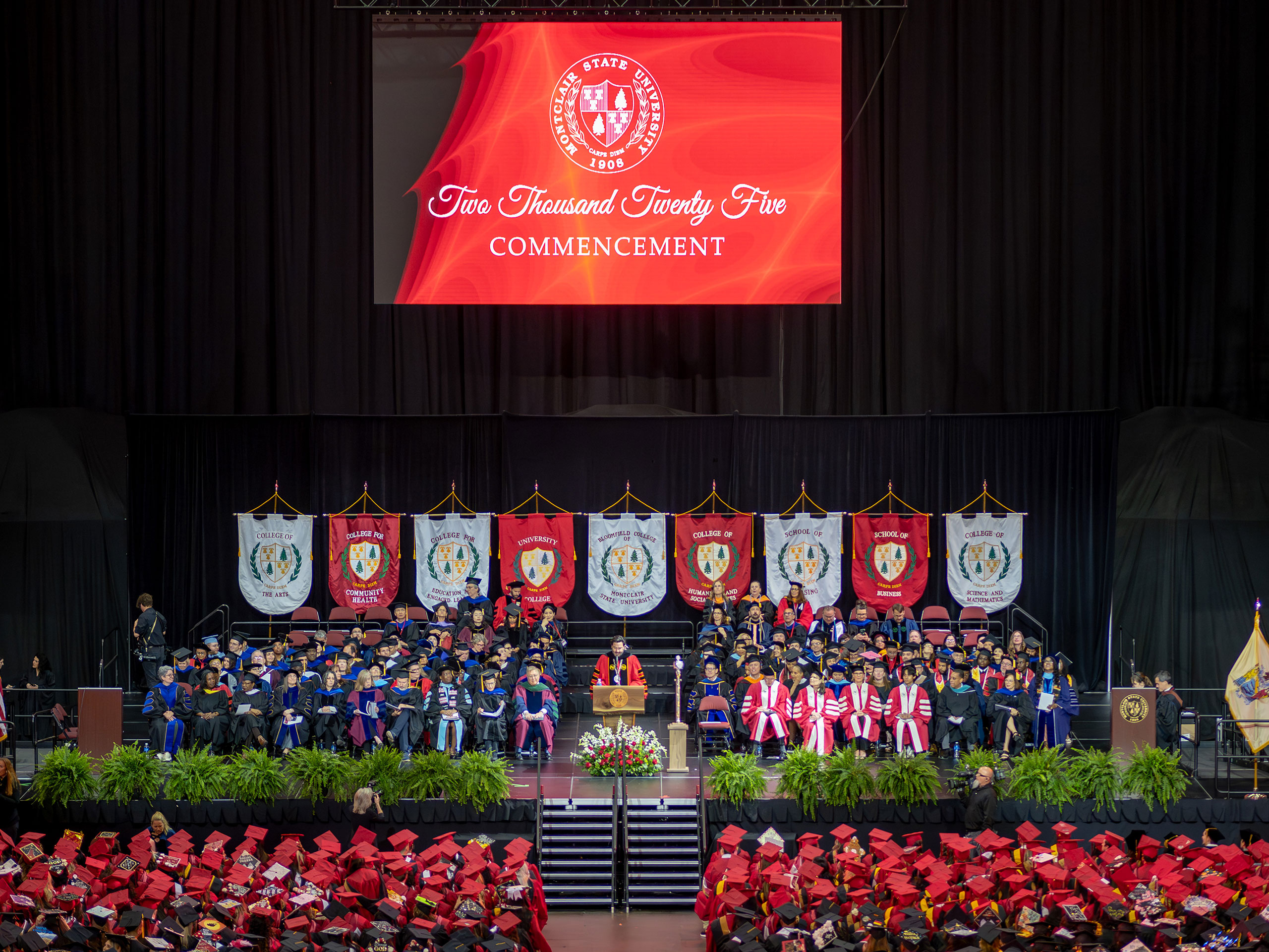 Deans, faculty and staff seated on stage at Prudential Center