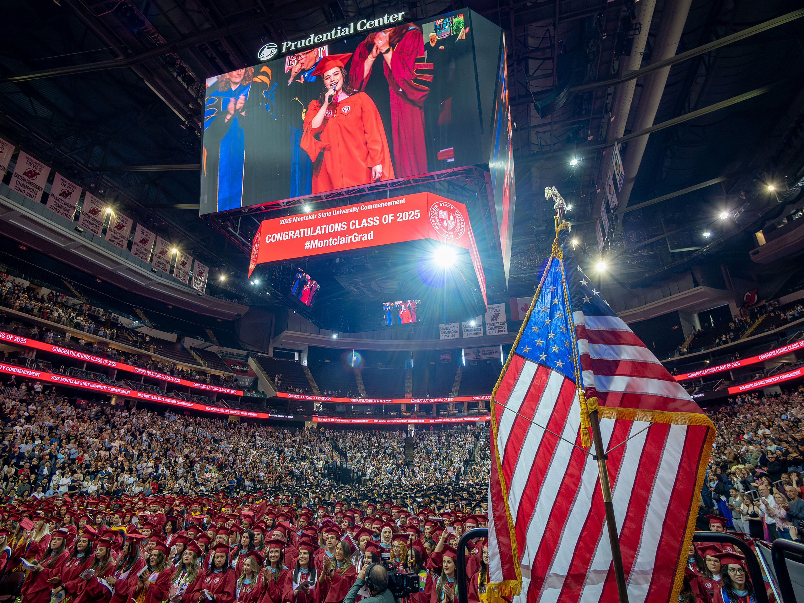 photo of Prudential Center jumbotron showing graduate Sydney Emile Swearengin singing the national anthem