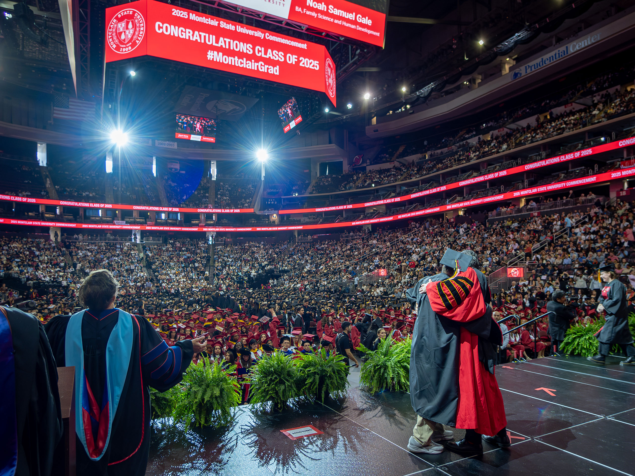 President Koppell embraces a graduate on stage
