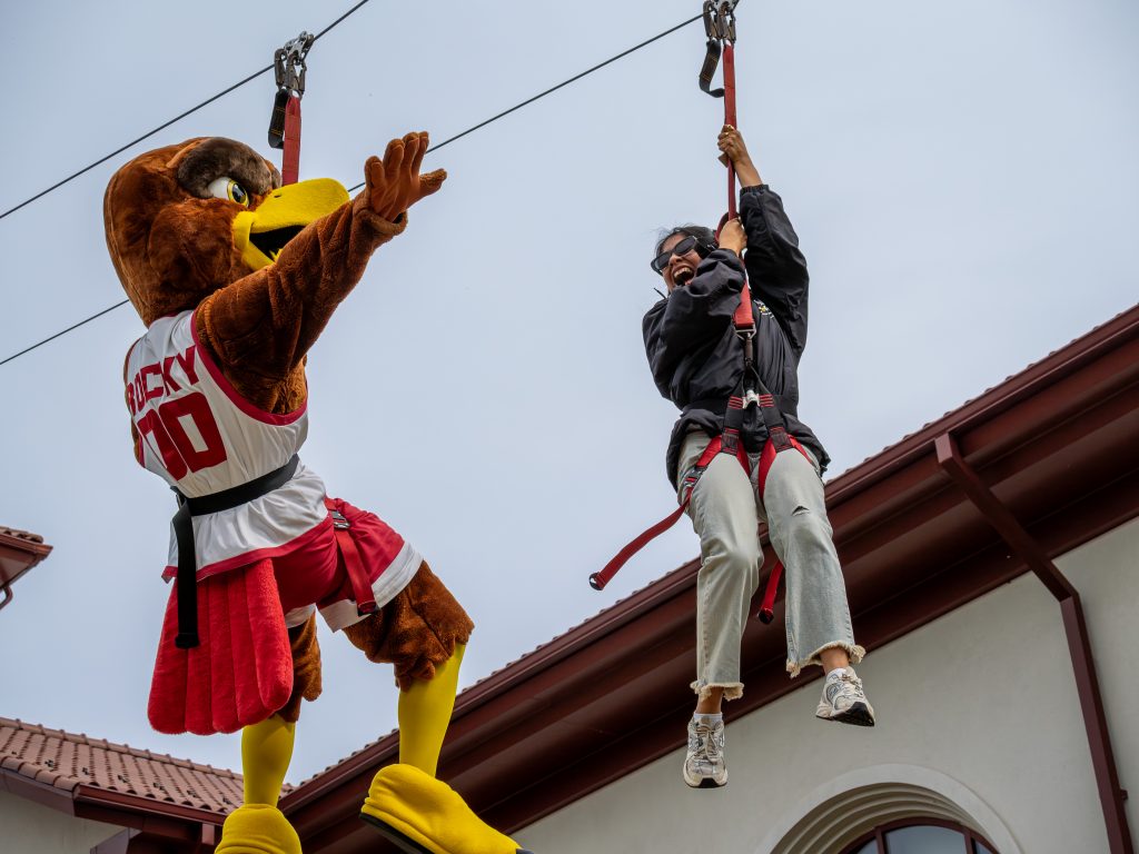 Rocky and student zip lining