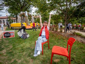 Student sitting in red chair