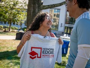 Sara Flores holds an Honors EDGE T-shirt.