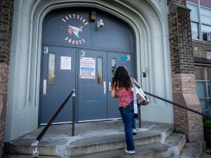 Sara climbs the steps to enter Eastside High School in Paterson, where she teaches English classes for adults.