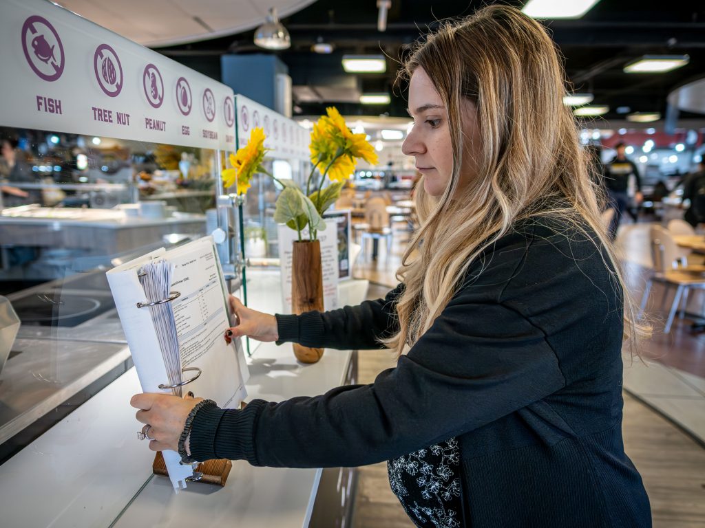 Woman adjusting pages of a book