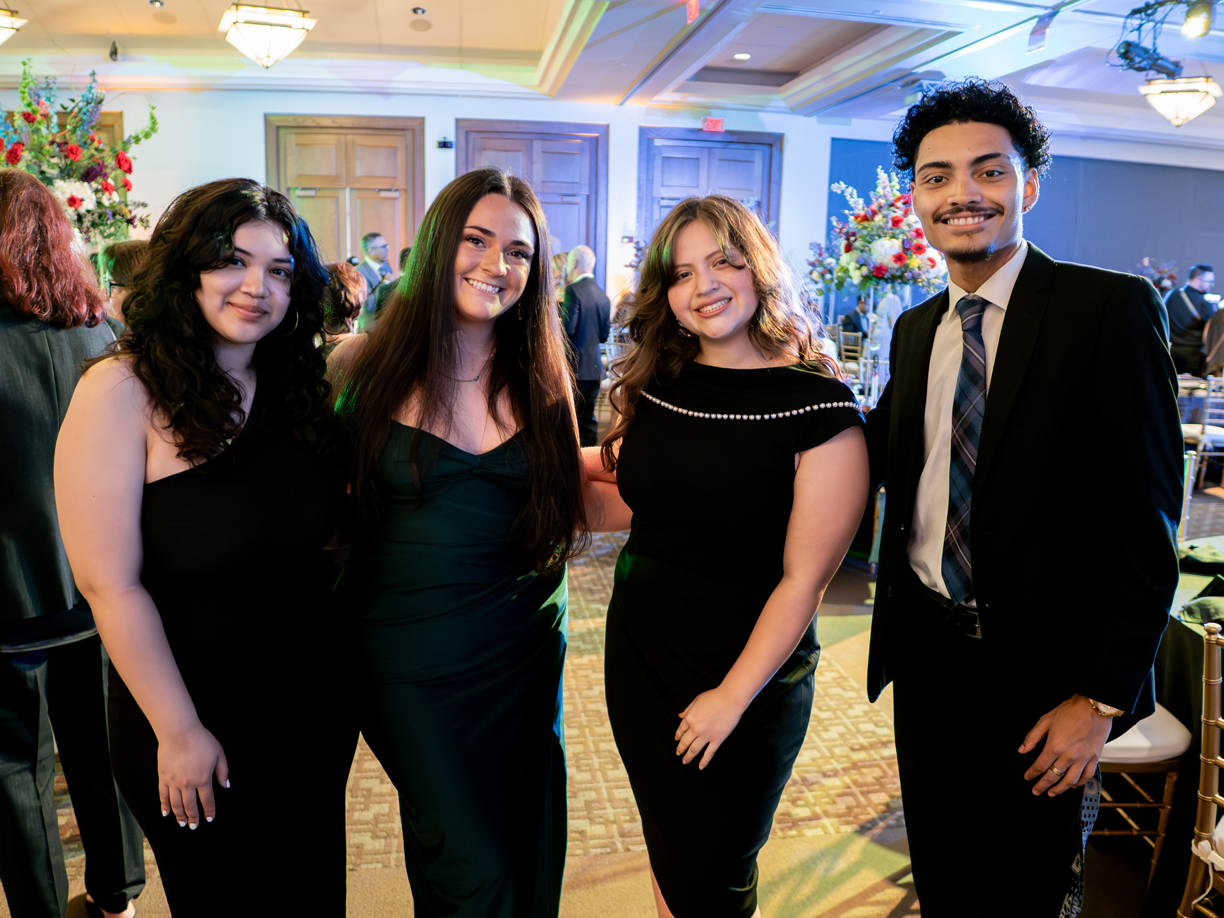 four people posing for a photo