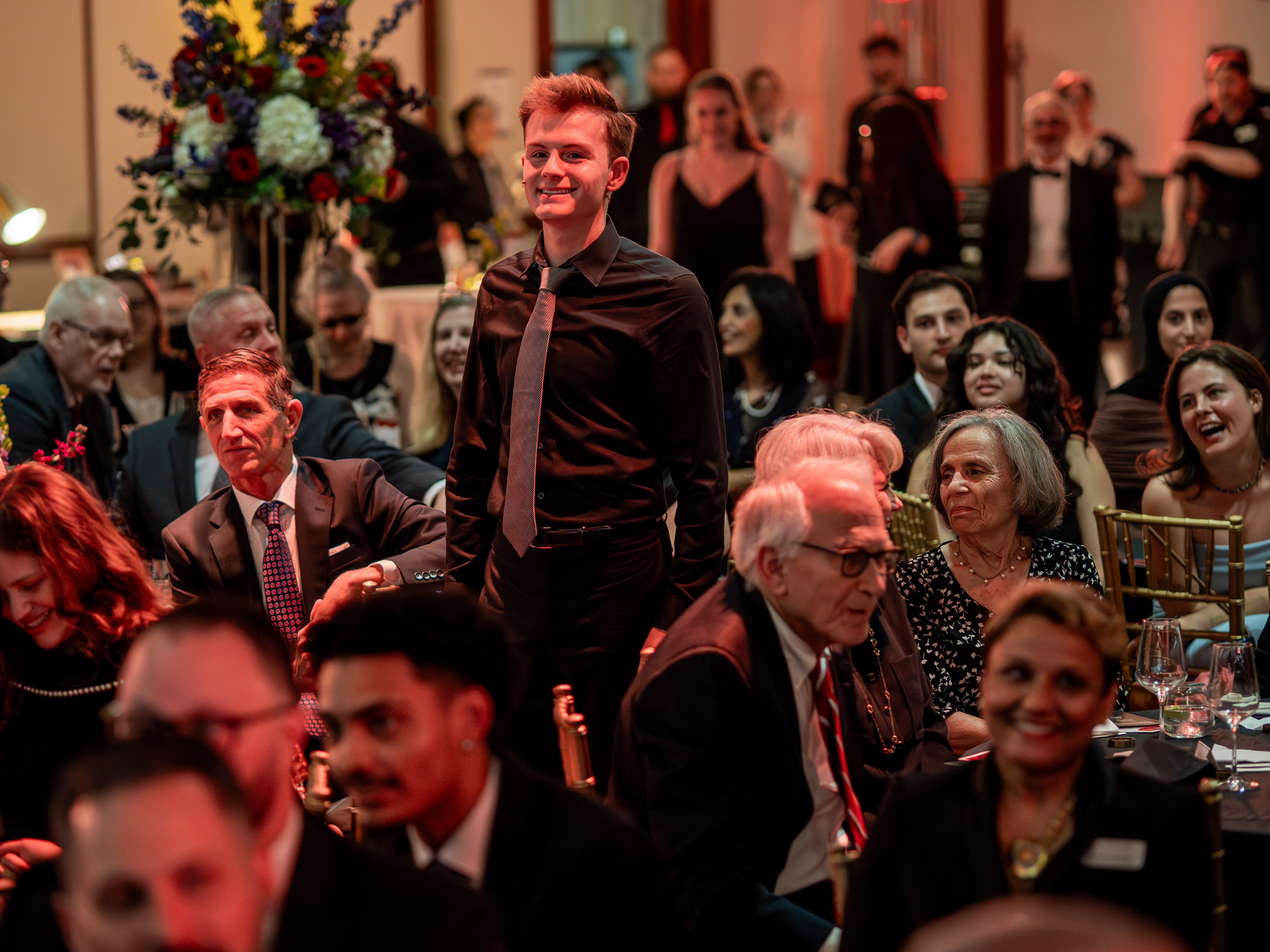 One person standing among seated guests