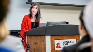 NJ First Lady Tammy Murphy standing behind podium with microphone.
