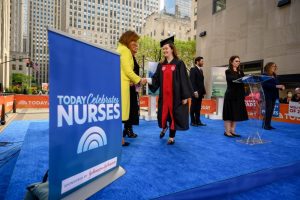 Photo of Montclair State nursing graduate on stage with the cast of The Today Show.